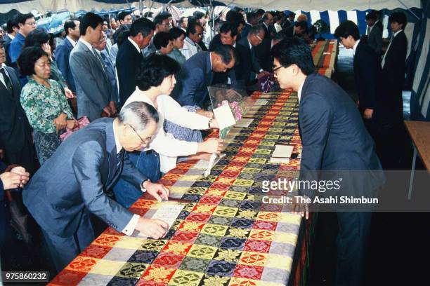 Well-wishers praying for Emperor Hirohito's recoverty sign at the Imperial Palace after the emperor vomiting blood on September 22, 1988 in Tokyo,...