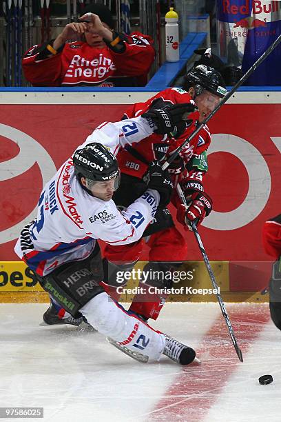 Tyler Bouck of Ingolstadt uses his stick against Bryan Adams of Koelner Haie during the DEL match between Koelner Haie and ERC Ingolstadt at the...