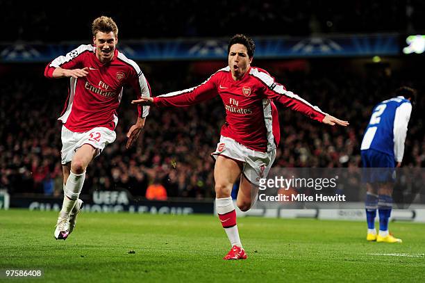 Samir Nasri of Arsenal celebrates with teammate Nicklas Bendtner after scoring his team's third goal during the UEFA Champions League round of 16...