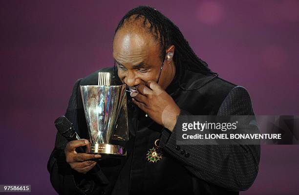 Singer Stevie Wonder jokes and takes off his glasses to "look at" his award of honor for his career during the 25th Victoires de la Musique yearly...