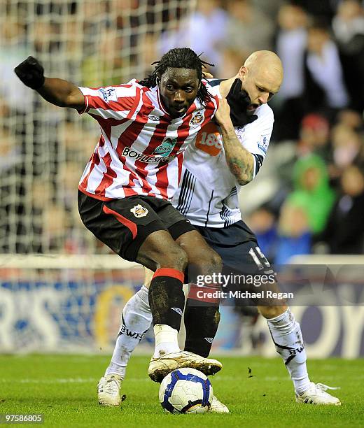 Kenwyne Jones of Sunderland holds off Gretar Steinsson of Bolton during the Barclays Premier League match between Sunderland and Bolton Wanderers at...