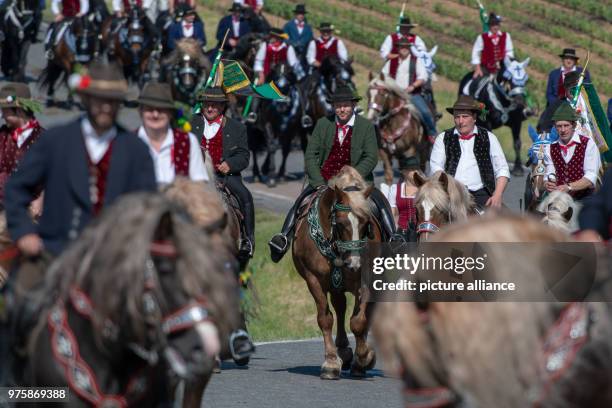 May 2018, Germany, Bad Koetzing: Participants of the Whit Monday procession ride their horses. This event, counting with almost 900 participants,...