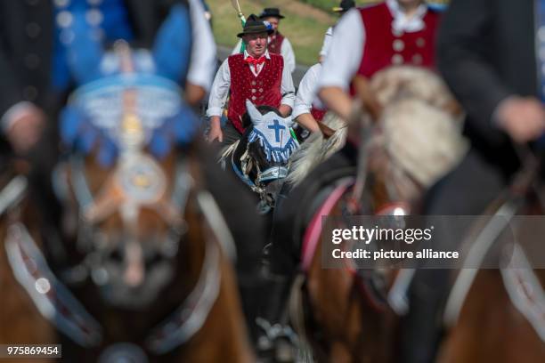 May 2018, Germany, Bad Koetzing: Participants of the Whit Monday procession ride their horses. This event, counting with almost 900 participants,...