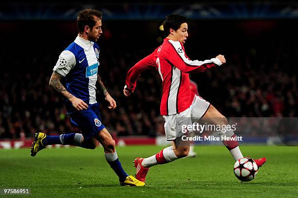 Samir Nasri of Arsenal goes past Raul Meireles of Porto enroute to scoring his team's third goal during the UEFA Champions League round of 16 match...