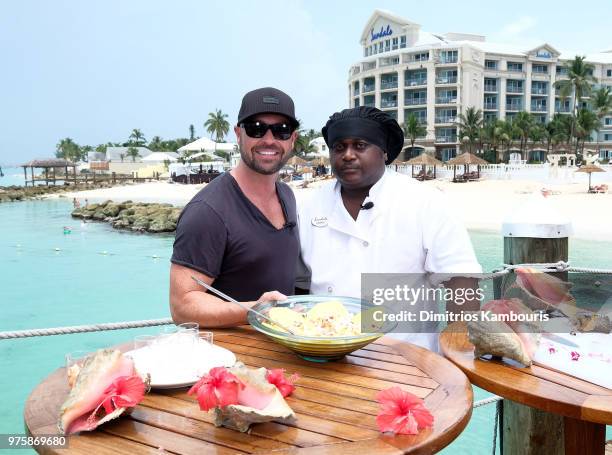 Cody Alan and Sandals Resort Chef Jamal prepare Bahamian conch salad at Sandals Royal Bahamian Spa Resort & Offshore Island on June 15, 2018 in...