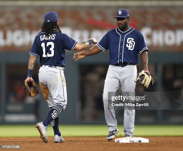 Shortstop Freddy Galvis and second baseman Jose Pirela of the San Diego Padres shake hands after the game against the Atlanta Braves at SunTrust Park...