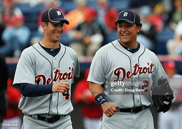 Starting pitcher Rick Porcello of the Detroit Tigers shares a laugh with first baseman Miguel Cabrera after ending the third inning against the...