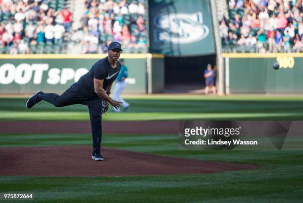 Seattle Seahawks quarterback Russell Wilson throws out the ceremonial first pitch before the game between the Seattle Mariners and the Boston Red Sox...