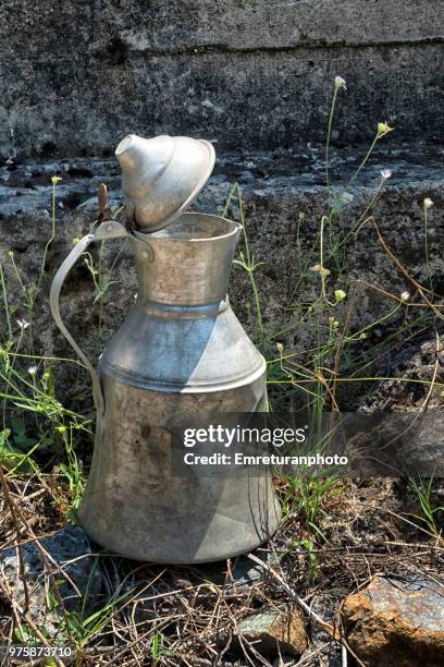 metal water pitcher in the field. - emreturanphoto foto e immagini stock