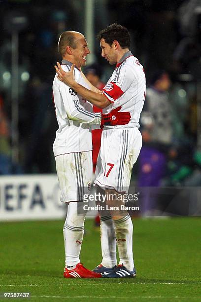 Arjen Robben of Muenchen celebrates with team mate Mark van Bommel after the UEFA Champions League round of sixteen, second leg match between AFC...