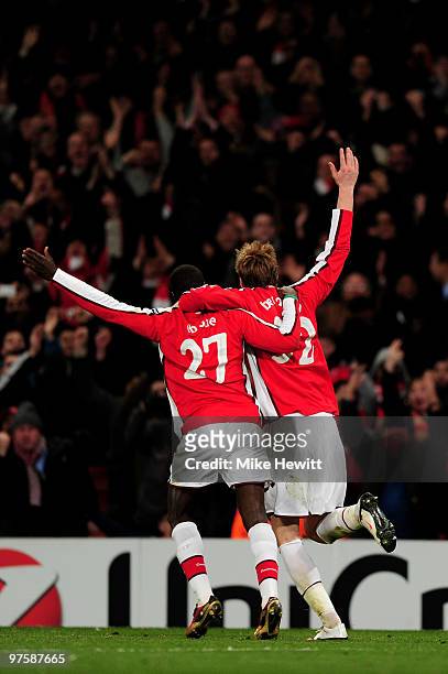 Penalty winner Emmanuel Eboue and penalty scorer Nicklas Bendtner of Arsenal celebrate after their team's fifth goal during the UEFA Champions League...