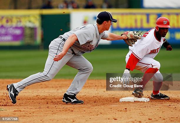 Outfielder Nyjer Morgan of the Washington Nationals steals second base ahead of the tag from second baseman Brent Dlugach of the Detroit Tigers at...