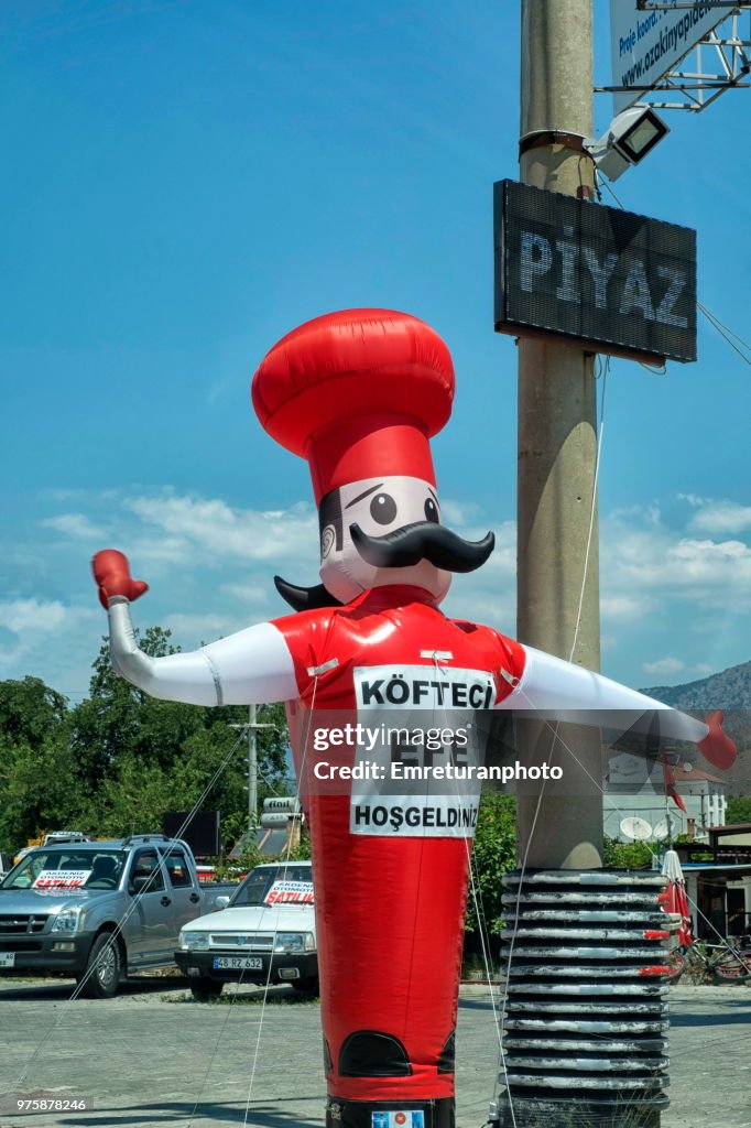 Inflated chef sign near Cine in Aegean Turkey.