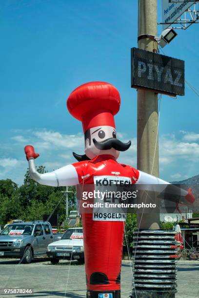 inflated chef sign near cine in aegean turkey. - emreturanphoto stock pictures, royalty-free photos & images