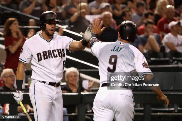 David Peralta of the Arizona Diamondbacks high fives Jon Jay after Jay scored a run against the New York Mets during the third inning of the MLB game...