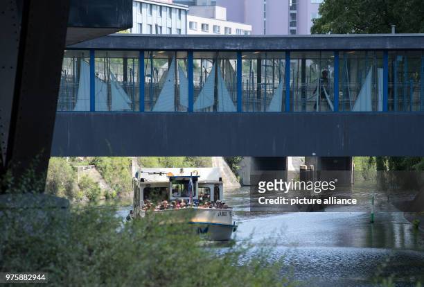 May 2018, Germany, Berlin: The excursion boat 'La Belle' drives underneath the U-Bahn station Moeckernbruecke's pedestrian bridge along on the...