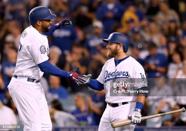 Matt Kemp of the Los Angeles Dodgers celebrates his solo homerun with Max Muncy to take a 2-0 lead over the San Francisco Giants during the fourth...