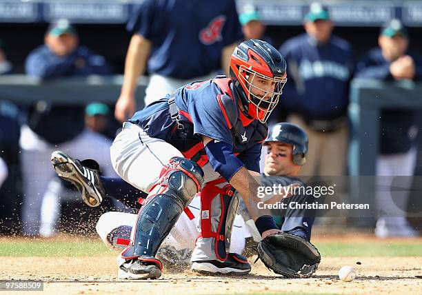 Catcher Wyatt Toregas of the Cleveland Indians catches the ball as Ryan Garko of the Seattle Mariners slides in to score during the fourth inning of...