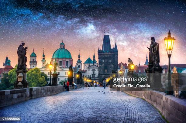 view of charles bridge in prague at night with milky way. czech republic - prague stock pictures, royalty-free photos & images
