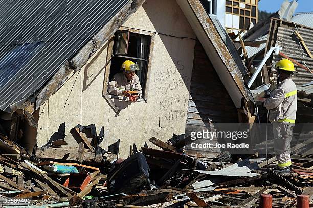 Firemen search for bodies that may be in homes that were destroyed by the February 27th earthquake and following tsunami on March 9, 2010 in Dichato,...