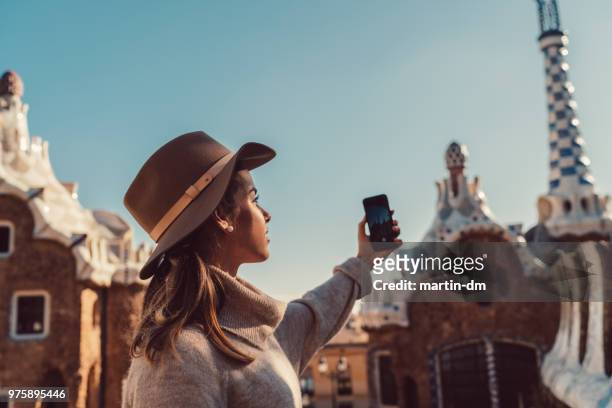 woman traveler exploring europe with smartphone - park guell stock pictures, royalty-free photos & images