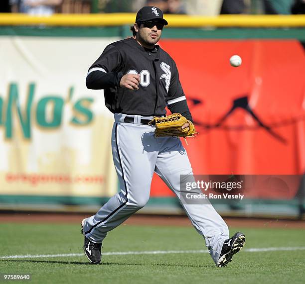 Carlos Quentin of the Chicago White Sox fields against the San Francisco Giants during a spring training game at Scottsdale Stadium March 9, 2010 in...