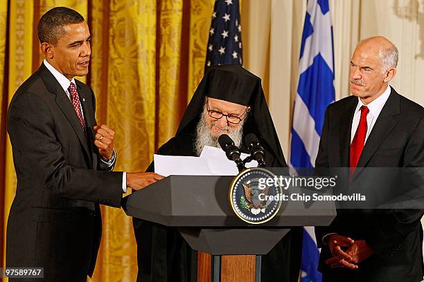 President Barack Obama helps Archbishop Demetrios, Primate of the Greek Orthodox Church in America, with his notes as Greek Prime Minister George...