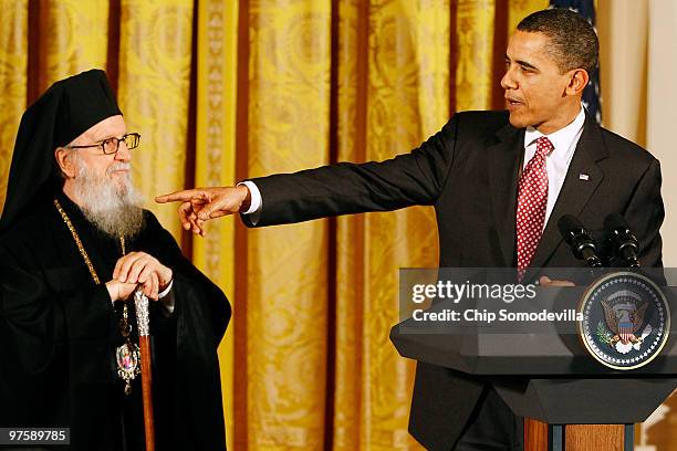 President Barack Obama gestures toward Archbishop Demetrios, Primate of the Greek Orthodox Church in America, during an event marking Greek...