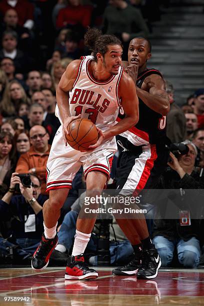 Joakim Noah of the Chicago Bulls drives past Dante Cunningham of the Portland Trail Blazers during the game at the United Center on February 26, 2010...