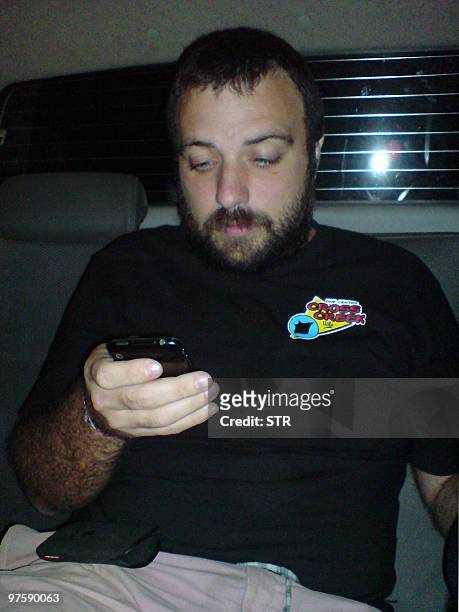 Spanish Jorda Correcher uses his mobile phone after being arrested in Livigston, Izabal, 340 kilometers north of Guatemala City on March 9, 2010....