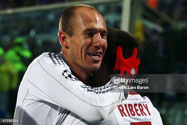 Arjen Robben of Muenchen celebrates with teammate Franck Ribery after scoring his teams second goal during the UEFA Champions League round of...