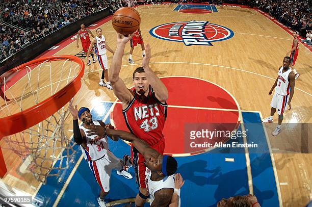 Kris Humphries of the New Jersey Nets shoots over Ben Wallace and Richard Hamilton of the Detroit Pistons during the game at the Palace of Auburn...