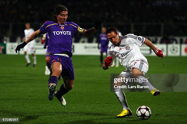 Riccardo Montolivo of Florence challenges Franck Ribery of Muenchen during the UEFA Champions League round of sixteen, second leg match between AFC...