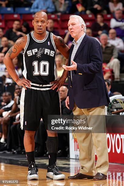 Head coach Gregg Popovich and Keith Bogans of the San Antonio Spurs talk during the game against the Sacramento Kings at Arco Arena on February 3,...