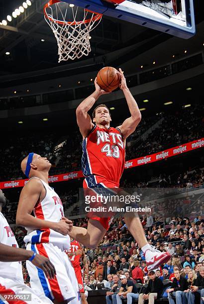 Kris Humphries of the New Jersey Nets takes the ball to the basket against Charlie Villanueva of the Detroit Pistons during the game at the Palace of...