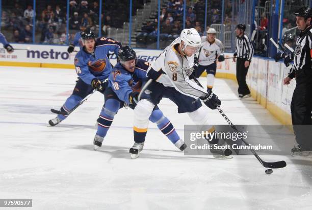 Kevin Klein of the Nashville Predators battles for the puck against Bryan Little of the Atlanta Thrashers at Philips Arena on March 9, 2010 in...