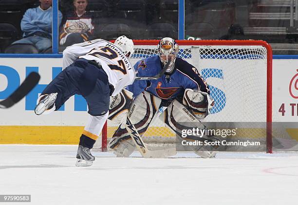 Johan Hedberg of the Atlanta Thrashers makes a save against Patric Hornqvist of the Nashville Predators at Philips Arena on March 9, 2010 in Atlanta,...