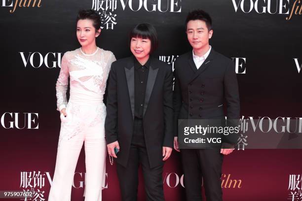 Actress Li Bingbing, Vogue China editor-in-chief Angelica Cheung and actor Huang Xuan pose on the red carpet of 2018 Vogue Film Gala on June 15, 2018...
