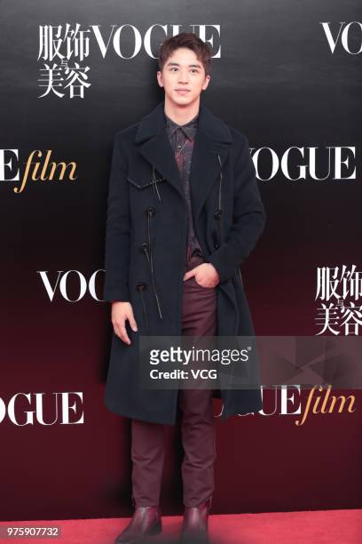 Actor Xu Weizhou poses on the red carpet of 2018 Vogue Film Gala on June 15, 2018 in Shanghai, China.