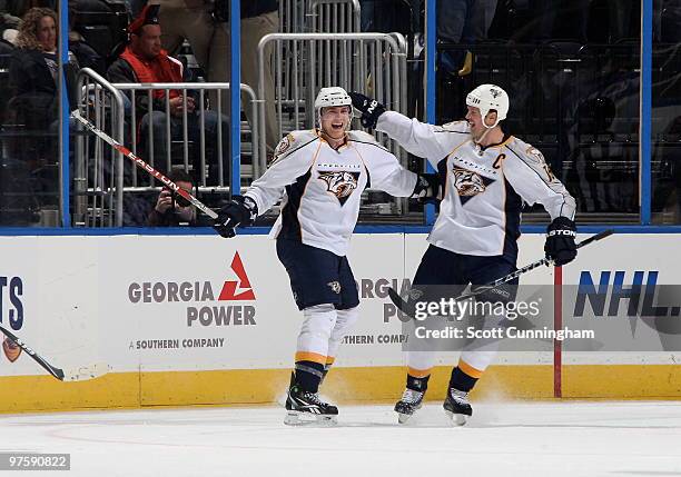 Colin Wilson of the Nashville Predators is congratulated by Jason Arnott after scoring a first period goal against the Atlanta Thrashers at Philips...