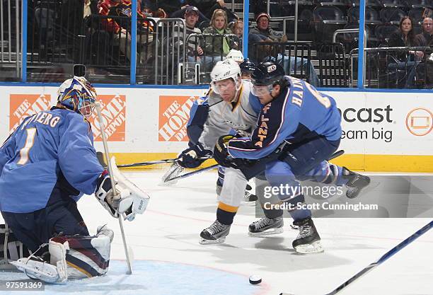 Johan Hedberg of the Atlanta Thrashers makes a save against the Nashville Predators as Ron Hainsey of the Thrashers defends at Philips Arena on March...