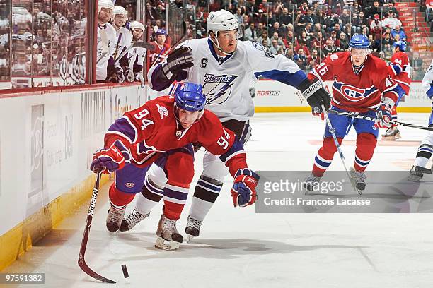 Tom Pyatt of Montreal Canadiens skates with the puck in front of Kurtis Foster of the Tampa Bay Lightning during the NHL game on March 9, 2009 at the...