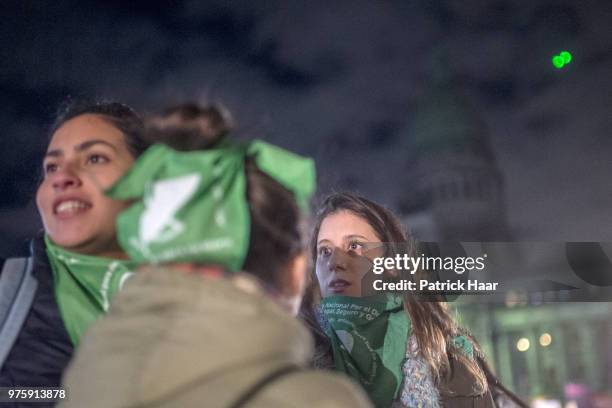 Women look on during a rally to demand legal and free abortion at Congressional Plaza on June 13, 2018 in Buenos Aires, Argentina. A bill to...