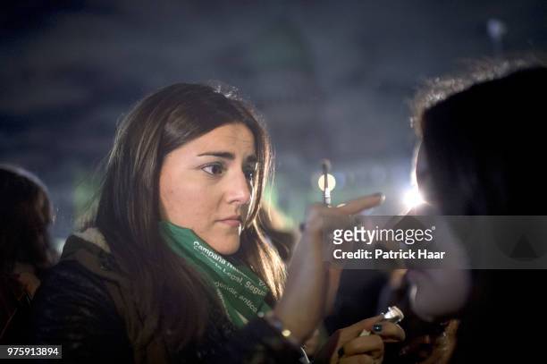 Woman paints the face of another during a rally to demand legal and free abortion at Congressional Plaza on June 13, 2018 in Buenos Aires, Argentina....