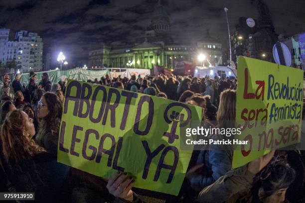 Woman holds up a sign that reads 'Legal abortion now - The revolution will be feminist or it will not be' during a rally to demand legal and free...