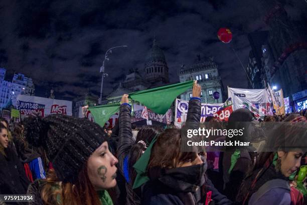 Women look on during a rally to demand legal and free abortion at Congressional Plaza on June 13, 2018 in Buenos Aires, Argentina. A bill to...