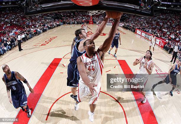 Chuck Hayes of the Houston Rockets shoots a layup against Mehmet Okur of the Utah Jazz during the game at Toyota Center on February 16, 2010 in...