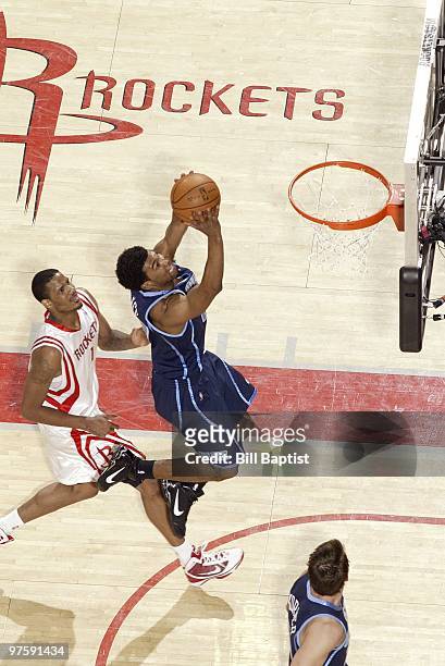 Ronnie Price of the Utah Jazz takes the ball to the basket against Trevor Ariza of the Houston Rockets during the game at Toyota Center on February...