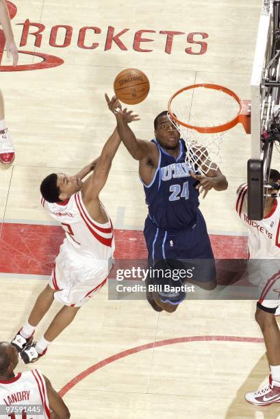 Paul Millsap of the Utah Jazz shoots a layup against Garrett Temple of the Houston Rockets during the game at Toyota Center on February 16, 2010 in...