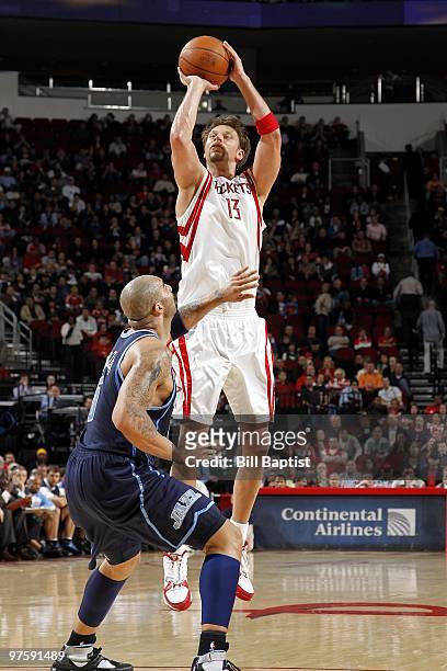 David Andersen of the Houston Rockets shoots a jump shot against Carlos Boozer of the Utah Jazz during the game at Toyota Center on February 16, 2010...